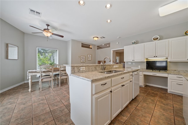 kitchen with sink, ceiling fan, an island with sink, white cabinets, and dishwasher