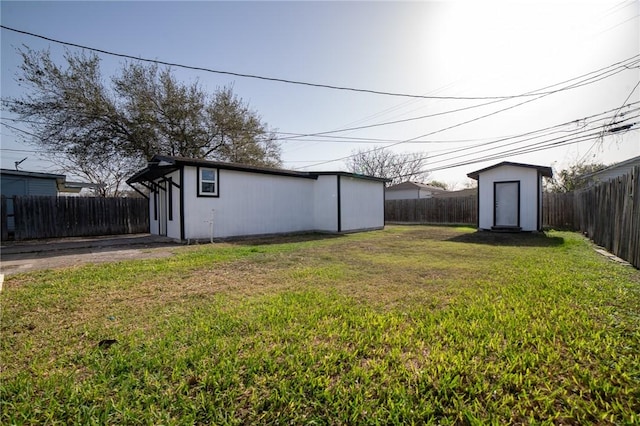 view of yard with an outdoor structure and a fenced backyard