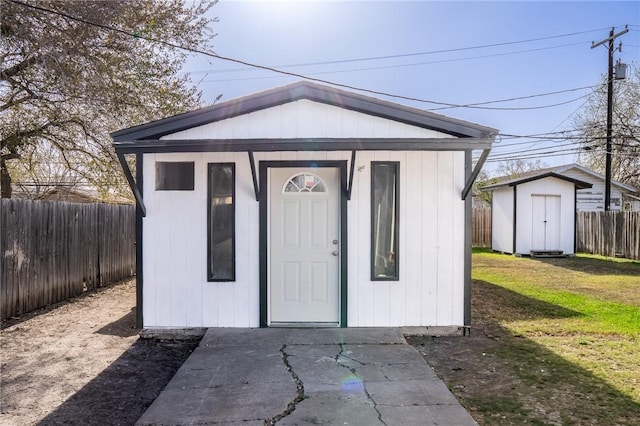 view of outbuilding featuring an outdoor structure and a fenced backyard