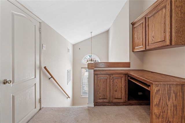 interior space with lofted ceiling, visible vents, and a chandelier