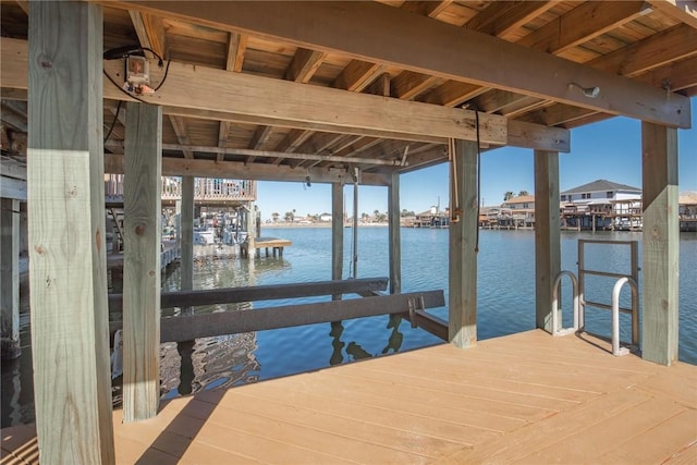 dock area with a water view and boat lift