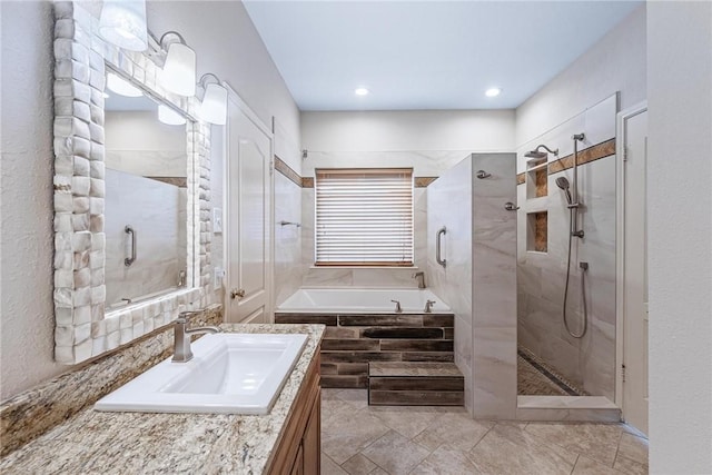 bathroom with a garden tub, a tile shower, and vanity