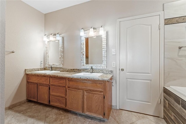 full bathroom featuring double vanity, a sink, and a bathtub