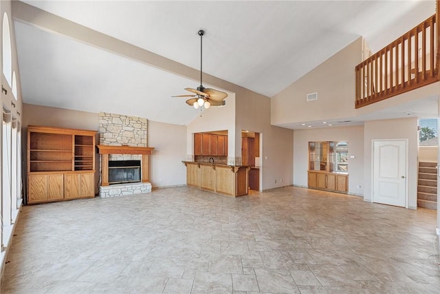 unfurnished living room featuring a fireplace, visible vents, vaulted ceiling, ceiling fan, and stairs