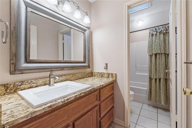 bathroom with tile patterned flooring, bathtub / shower combination, vanity, and toilet