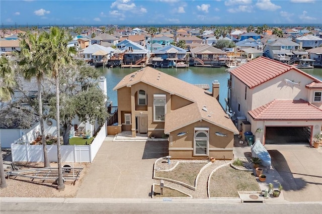 drone / aerial view featuring a water view and a residential view