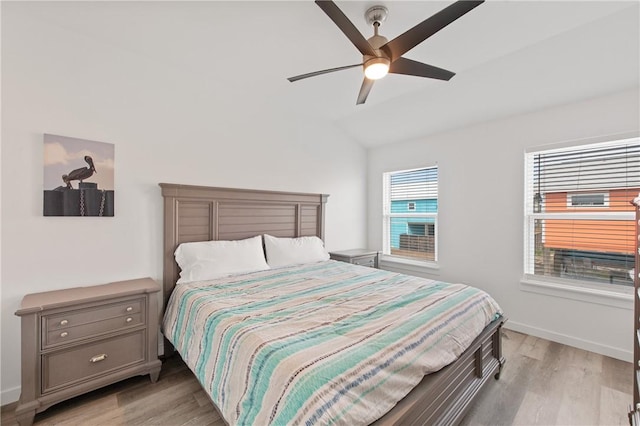 bedroom featuring vaulted ceiling, ceiling fan, and light hardwood / wood-style floors