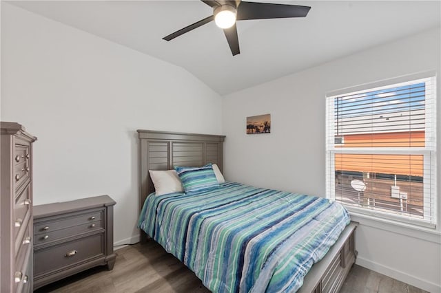 bedroom with wood-type flooring, lofted ceiling, and ceiling fan