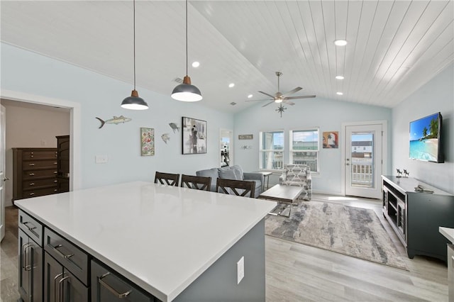 kitchen featuring a kitchen island, lofted ceiling, hanging light fixtures, wood ceiling, and light wood-type flooring