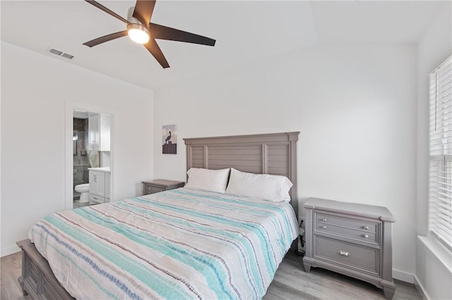 bedroom with ensuite bath, ceiling fan, and light wood-type flooring