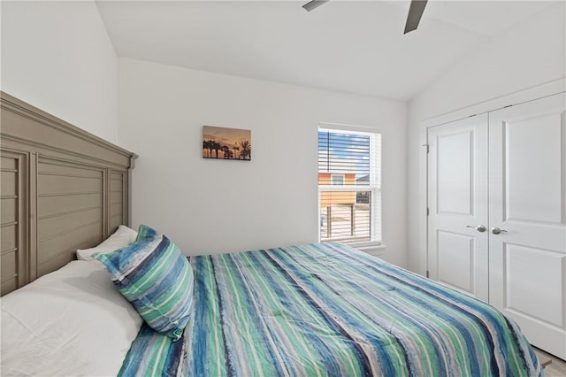 bedroom featuring ceiling fan, lofted ceiling, and a closet