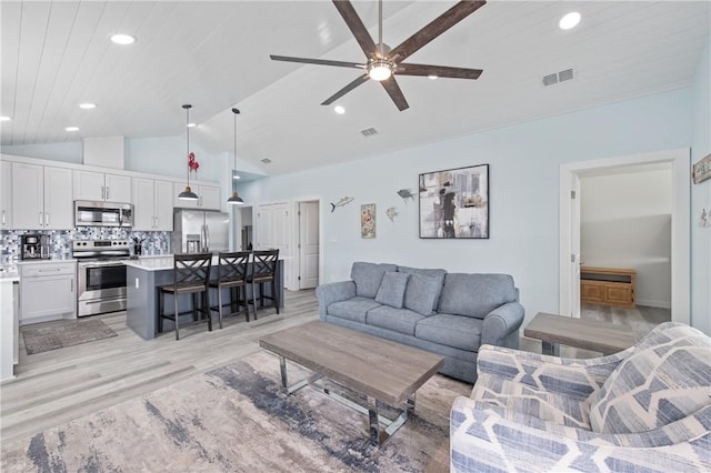 living room featuring lofted ceiling, wooden ceiling, ceiling fan, and light wood-type flooring