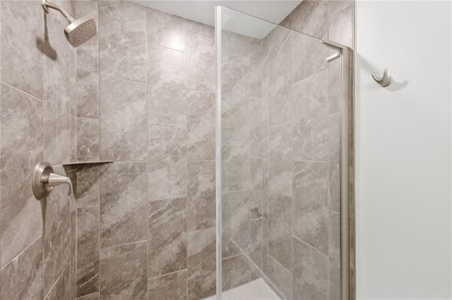 bathroom with a tile shower