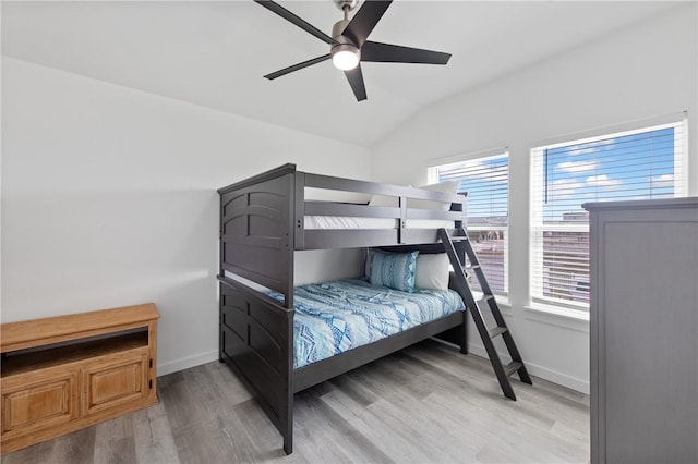 bedroom featuring vaulted ceiling, ceiling fan, and light wood-type flooring