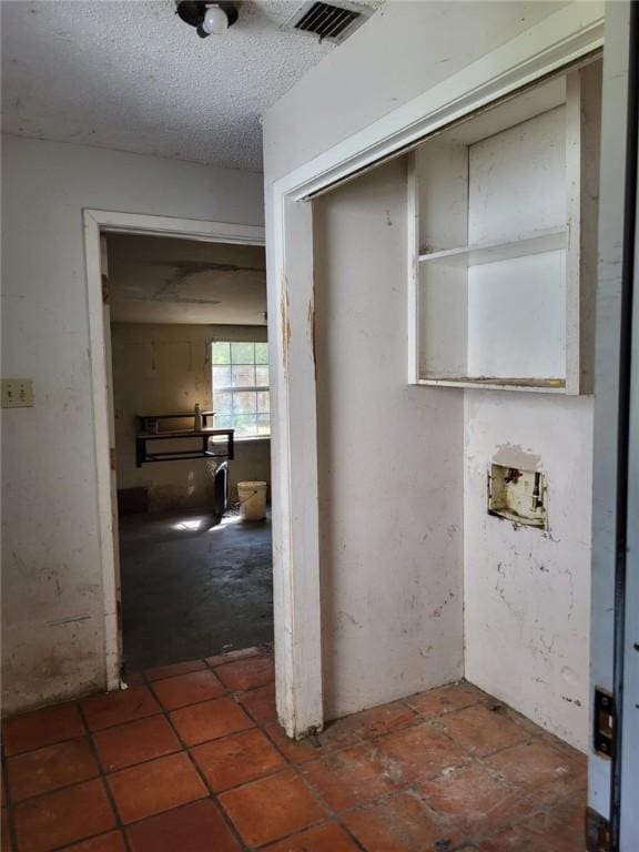 laundry area featuring a textured ceiling