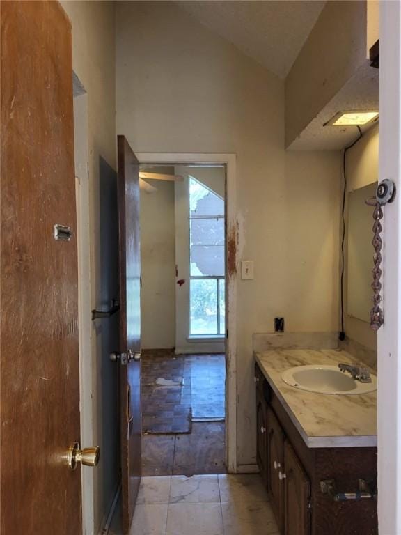 bathroom with vanity and lofted ceiling