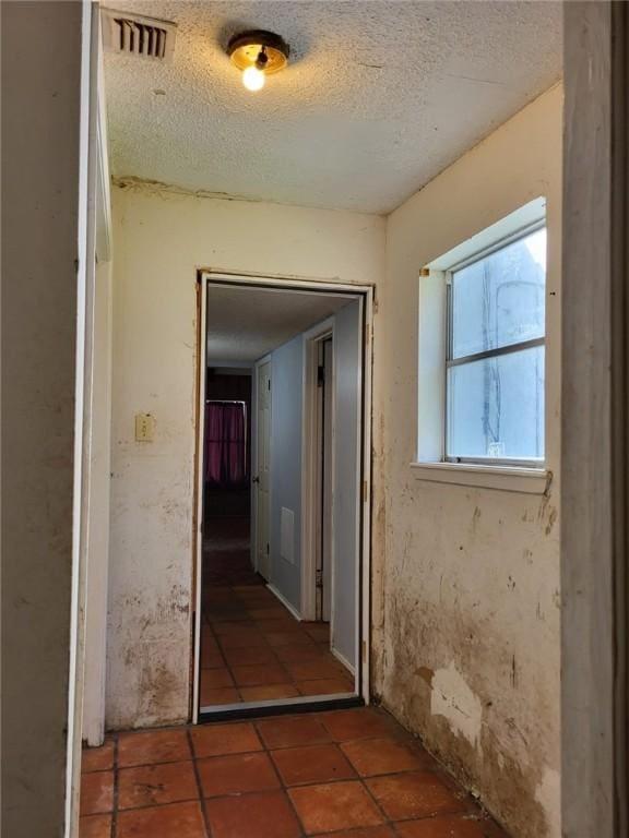 hallway with a textured ceiling