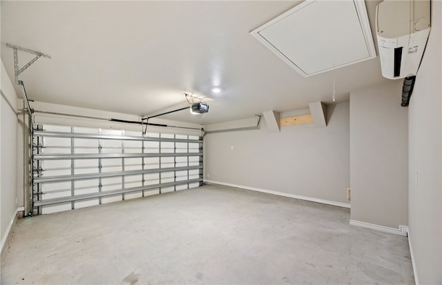 garage featuring a garage door opener and baseboards