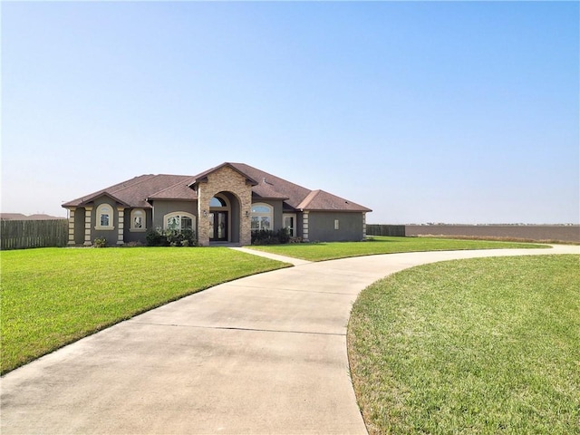 view of front facade with a front yard and fence