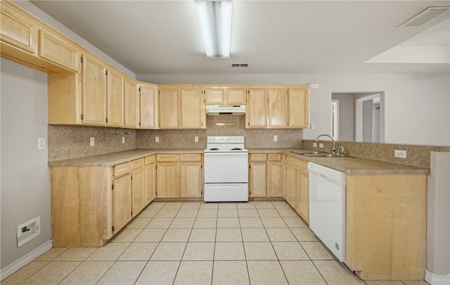 kitchen with light brown cabinets, visible vents, white appliances, and a sink