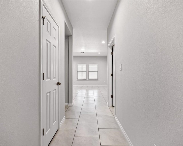 3901 Jayden Dr, Corpus Christi, TX 78410 - hallway with light tile patterned floors, baseboards, a textured wall, and recessed lighting