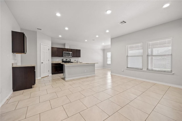 3901 Jayden Dr, Corpus Christi, TX 78410 - kitchen featuring appliances with stainless steel finishes, open floor plan, light countertops, recessed lighting, and a kitchen island with sink