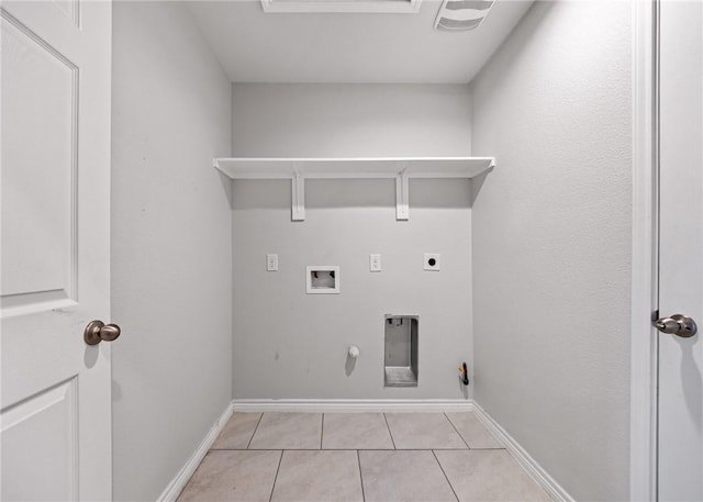 3901 Jayden Dr, Corpus Christi, TX 78410 - laundry area with hookup for a gas dryer, electric dryer hookup, hookup for a washing machine, light tile patterned floors, and baseboards