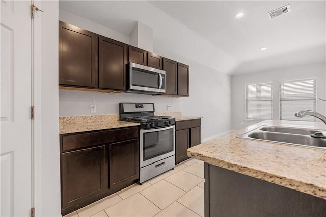 3901 Jayden Dr, Corpus Christi, TX 78410 - kitchen with stainless steel appliances, a sink, light countertops, dark brown cabinets, and recessed lighting