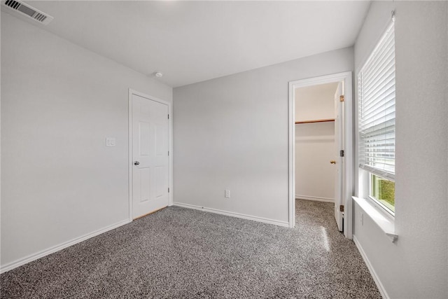3901 Jayden Dr, Corpus Christi, TX 78410 - unfurnished bedroom featuring carpet, a walk in closet, and baseboards