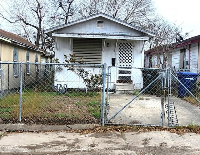 view of front of property featuring a fenced front yard and a gate