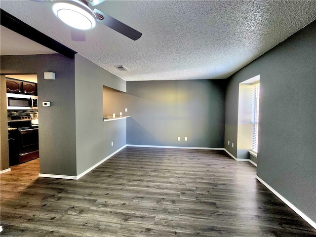 unfurnished room featuring a textured ceiling, dark hardwood / wood-style floors, and ceiling fan