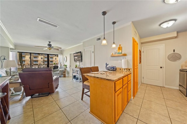 14514 E Cabana St, Corpus Christi, TX 78418 - kitchen with a kitchen bar, light tile patterned floors, range, a ceiling fan, and crown molding