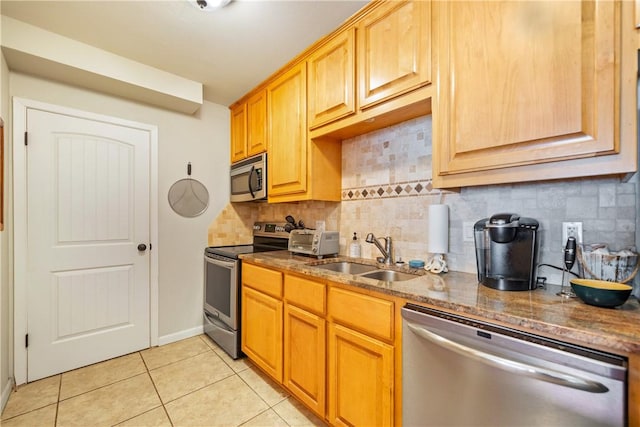 14514 E Cabana St, Corpus Christi, TX 78418 - kitchen with stainless steel appliances, light tile patterned flooring, dark stone countertops, and tasteful backsplash