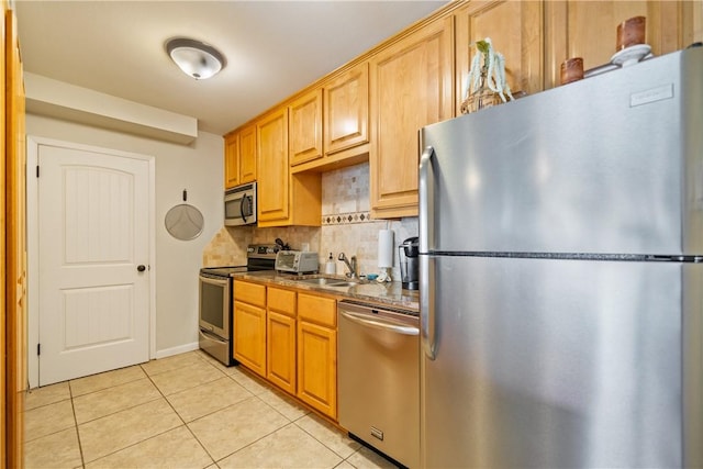 14514 E Cabana St, Corpus Christi, TX 78418 - kitchen with stainless steel appliances, light tile patterned floors, tasteful backsplash, and dark countertops