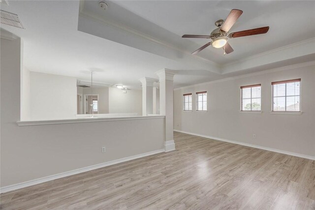 7706 Fort Griffen Dr, Corpus Christi, TX 78414 - spare room featuring wood finished floors, crown molding, ceiling fan, a tray ceiling, and baseboards