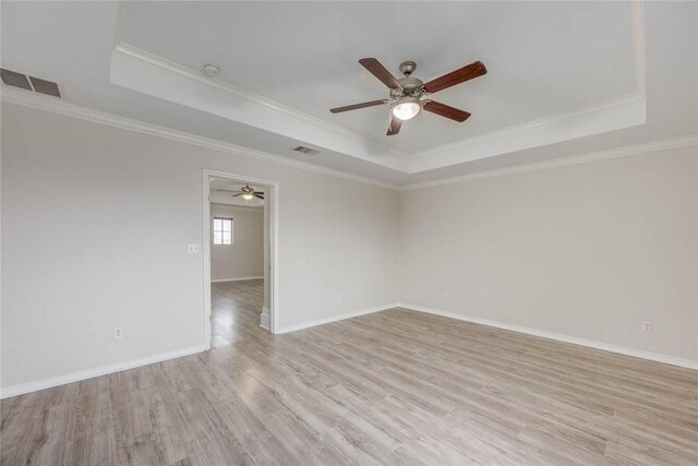 7706 Fort Griffen Dr, Corpus Christi, TX 78414 - unfurnished room featuring a tray ceiling, a ceiling fan, crown molding, light wood-style flooring, and baseboards