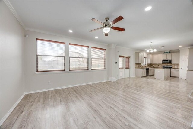 7706 Fort Griffen Dr, Corpus Christi, TX 78414 - unfurnished living room featuring crown molding, a ceiling fan, a chandelier, light wood-style flooring, and recessed lighting