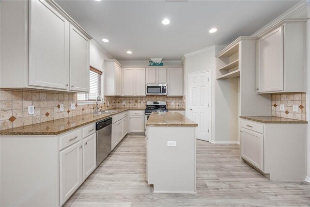 7706 Fort Griffen Dr, Corpus Christi, TX 78414 - kitchen with appliances with stainless steel finishes, a sink, a kitchen island, tasteful backsplash, and open shelves