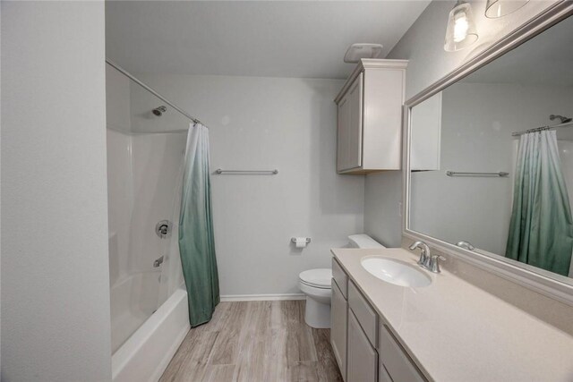7706 Fort Griffen Dr, Corpus Christi, TX 78414 - full bath featuring vanity, toilet, wood finished floors, shower / bath combo with shower curtain, and baseboards
