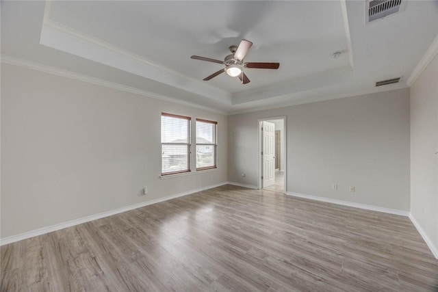 7706 Fort Griffen Dr, Corpus Christi, TX 78414 - spare room with a raised ceiling, ceiling fan, light wood-type flooring, crown molding, and baseboards