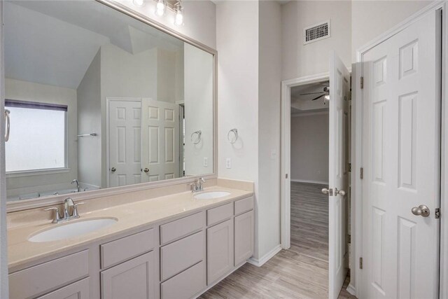 7706 Fort Griffen Dr, Corpus Christi, TX 78414 - bathroom featuring double vanity, wood finished floors, a ceiling fan, and baseboards