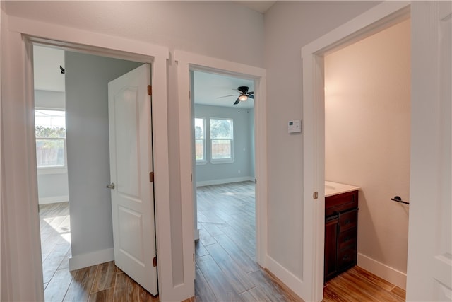 hallway with light hardwood / wood-style flooring