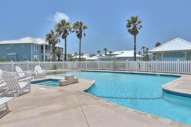 view of pool with a patio and a community hot tub