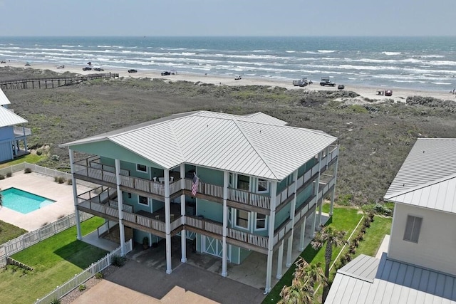 drone / aerial view featuring a water view and a beach view