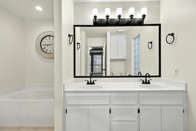 15341 Yardarm Ct, Corpus Christi, TX 78418 - full bathroom featuring a garden tub, double vanity, and tile patterned flooring