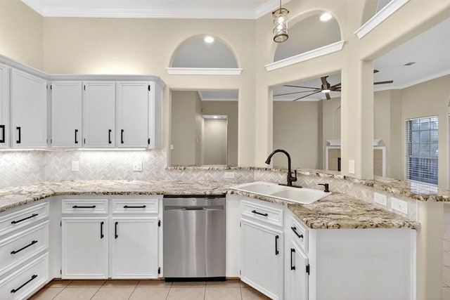 15341 Yardarm Ct, Corpus Christi, TX 78418 - kitchen with stainless steel dishwasher, a ceiling fan, decorative backsplash, a peninsula, and light stone countertops
