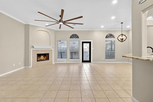 15341 Yardarm Ct, Corpus Christi, TX 78418 - unfurnished living room featuring ceiling fan, a fireplace, light tile patterned flooring, ornamental molding, and recessed lighting