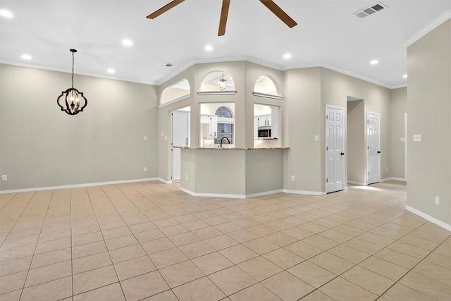 15341 Yardarm Ct, Corpus Christi, TX 78418 - unfurnished living room with ceiling fan, recessed lighting, crown molding, light tile patterned flooring, and a chandelier
