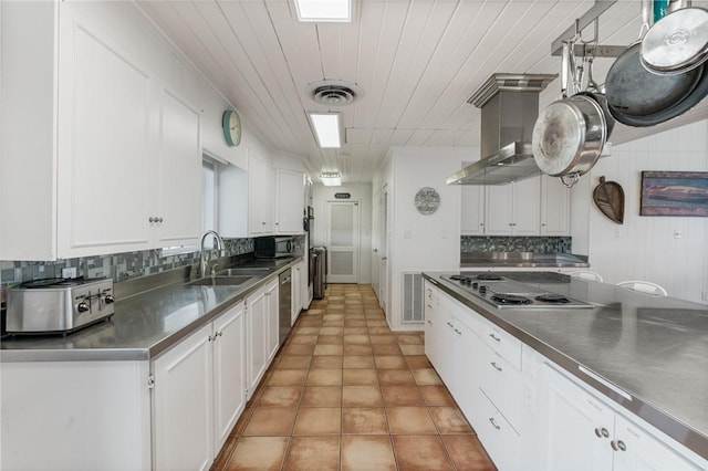 kitchen featuring stainless steel appliances, white cabinets, and stainless steel counters