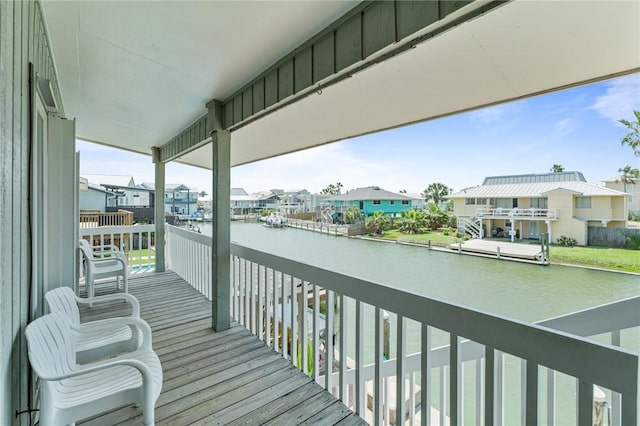 balcony featuring a water view and a residential view
